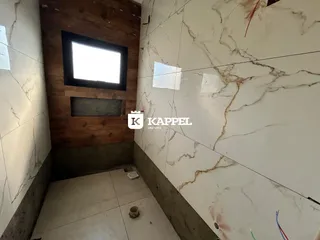 Hall de entrada com parede de madeira e revestimento de mármore nas paredes.