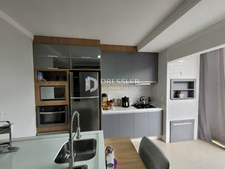 Cozinha moderna com armários de madeira e bancada clara.