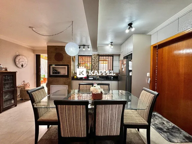 Foto de uma sala de jantar com mesa de vidro e cadeiras em um apartamento.
