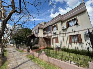 Fachada de uma residência em Lajeado, Brasil, com cerca e jardim na frente.