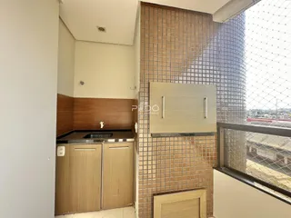Vista interna de um ambiente com bancada e revestimento de tijolo.