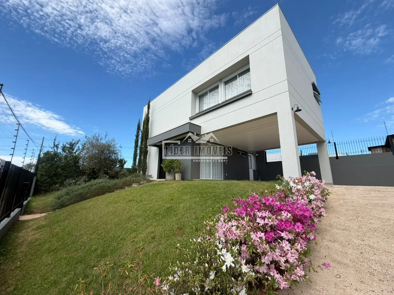Fachada moderna de uma casa em Lajeado, Brasil, com jardim em primeiro plano.