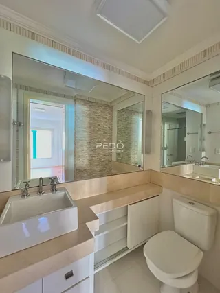 Foto de um banheiro com bancada dupla e vaso sanitário.
