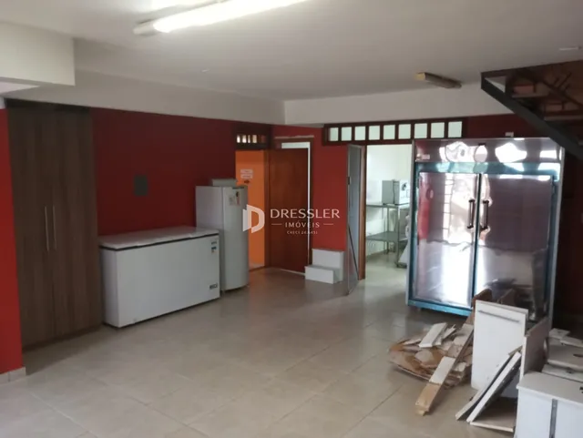 Interior de uma sala com paredes vermelhas e piso de cerâmica.