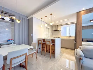 Ambiente moderno com sala de jantar e cozinha em um imóvel no Brasil.