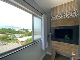 Ambiente interno com grande janela oferecendo vista para a paisagem externa.