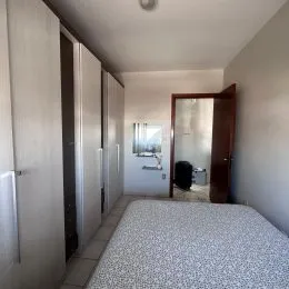Foto interna de um quarto com cama.