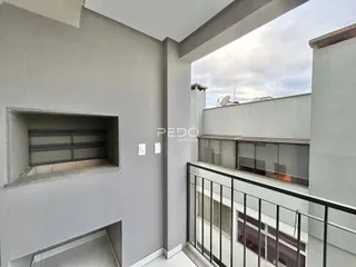 Vista de um corredor interno com acesso a uma varanda.