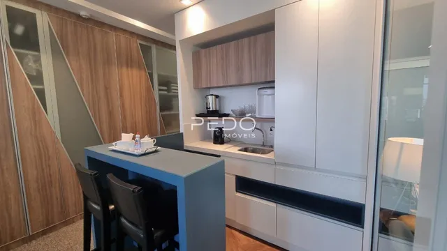 Foto de uma cozinha moderna com armários em madeira e ilha azul.