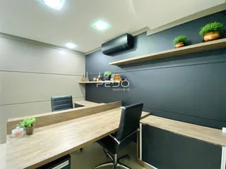Foto de uma sala de jantar com mesa de madeira e prateleiras na decoração.