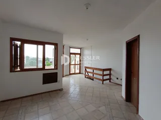 Corredor interno de uma residência com piso de cerâmica e molduras de madeira.