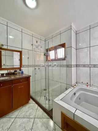 Imagem de um banheiro com box de vidro e banheira em Lajeado, Brasil.