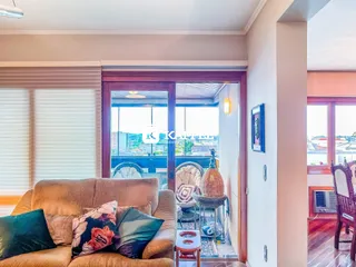 Uma sala de estar com sofá e vista para o exterior.