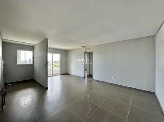 Interior de uma sala ampla com piso de cerâmica e vista externa.