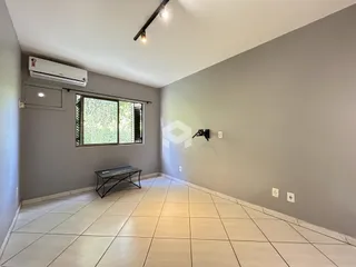 Ambiente interno de uma sala com piso de cerâmica e parede cinza.