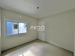 Foto de um ambiente interno com paredes brancas e piso claro.