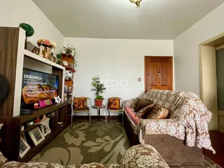 Sala de estar com estante de madeira e sofá decorado.
