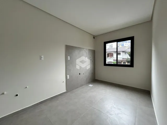Foto de um ambiente interno com paredes brancas e piso de cerâmica.