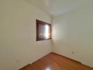 Vista da parede de um cômodo com piso de madeira clara.
