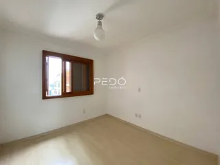 Ambiente interno de uma sala com piso claro e janela em um imóvel em Lajeado.