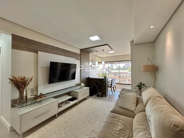 Sala de estar moderna com sofá e televisão.