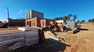 Vista externa de uma obra em Lajeado, Brasil, com materiais de construção no primeiro plano.