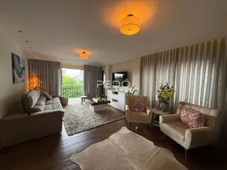 Sala de estar com decoração moderna e piso de madeira.