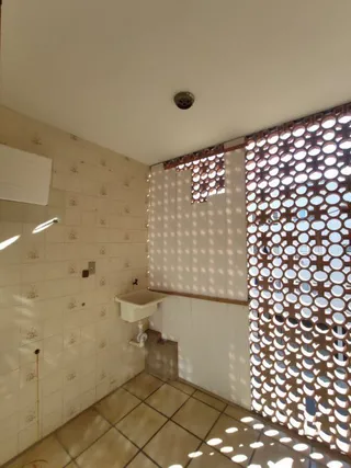 Interior de um cômodo com piso e paredes de cerâmica.