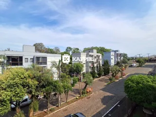 Vista externa de edifícios residenciais e área verde em Lajeado, Brasil.