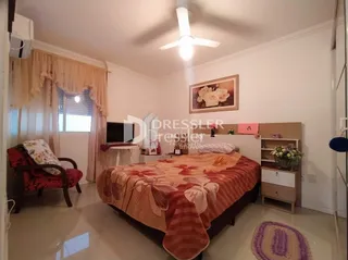 Quarto com cama e cortinas em um imóvel.