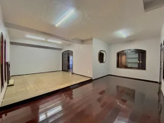 Sala ampla com piso de madeira polida.
