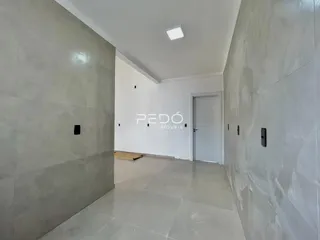 Hall de entrada com paredes cinzas e piso claro em imóvel no Brasil.