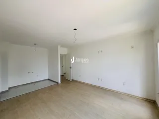 Sala de estar com piso de madeira clara e paredes brancas.