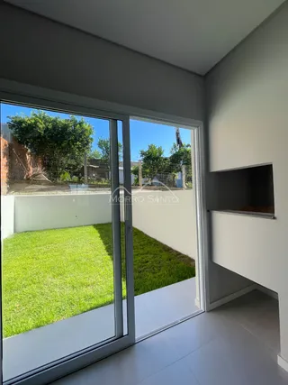 Ambiente interno com portas de vidro que dão acesso a um gramado.