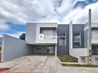 Fachada moderna de um prédio residencial em Lajeado, Brasil, com detalhes em branco e cinza.