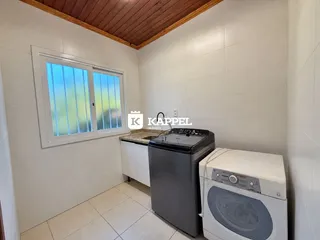 Esta é uma foto de uma cozinha com fogão e máquina de lavar roupa.