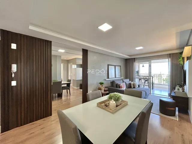 Sala de estar com piso de madeira e vista para a varanda.