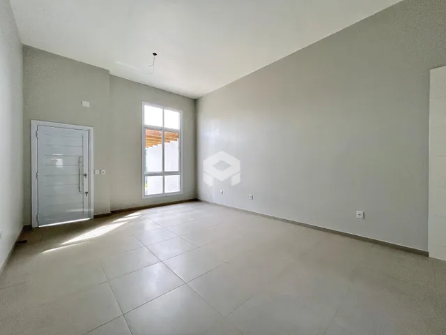 Interior de uma sala com piso de cerâmica e paredes brancas.