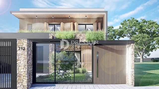 Fachada moderna de uma residência em Lajeado, Brasil, com revestimento de pedra e madeira.