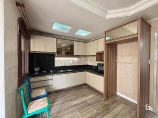 Foto de uma cozinha com armários e piso de madeira em Lajeado.