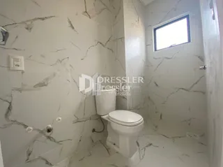 Foto de um banheiro com paredes revestidas em mármore branco.