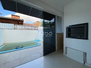 A sala de estar dá acesso a uma área externa com piscina.