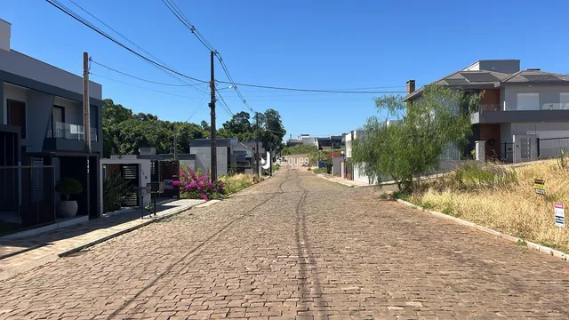 Vista da rua em Lajeado, Brasil, mostrando casas e uma via pavimentada.