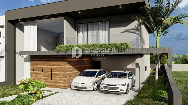 Fachada moderna de uma residência em Lajeado, Brasil, com garagem e paisagismo.