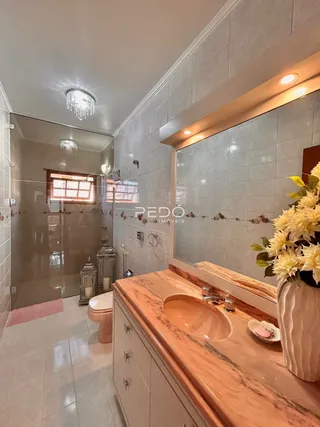 Vista de um corredor interno com revestimento de cerâmica e espelho.