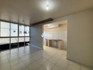 Ambiente interno com grandes janelas e piso de cerâmica clara.