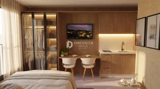 Quarto com guarda-roupa e área de cozinha integrada.