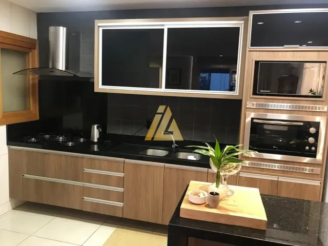 Foto de uma cozinha com armários escuros e bancada escura.