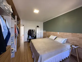 Quarto com cama e armários em um ambiente claro.