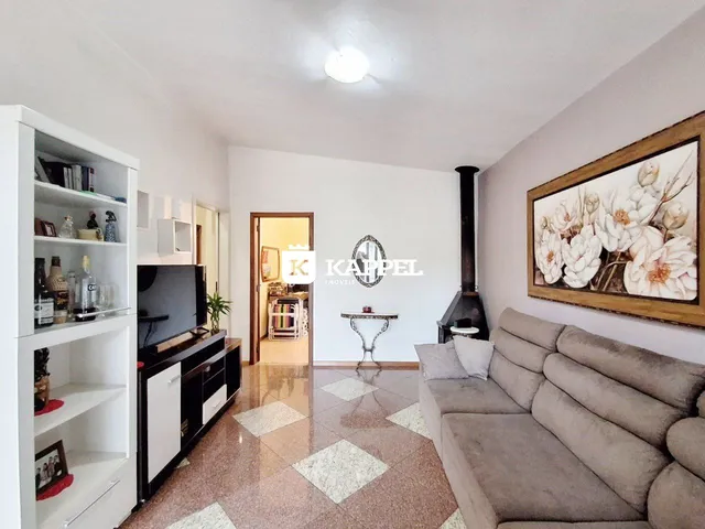 Sala de estar com sofá e televisão em um apartamento.